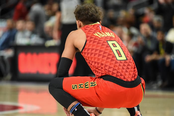 Atlanta Hawks guard Trae Young (11) wearing jersey number 8 to start the game to honor the memory of former NBA player Kobe Bryant holds the ball for 8 seconds at the start of the game against the Washington Wizards at State Farm Arena.